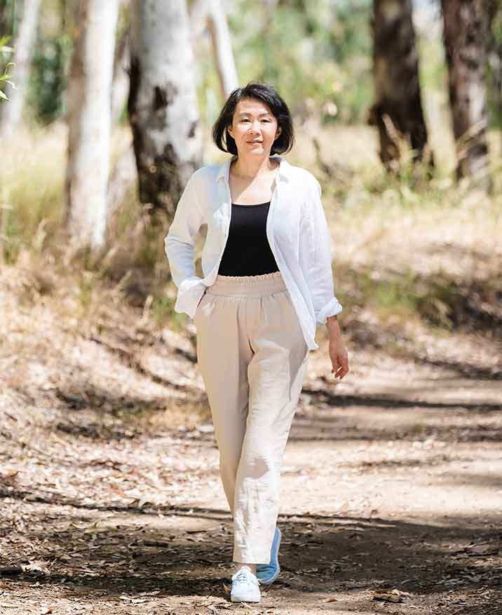 Xiaoyun walking on a dirt path in the woods
