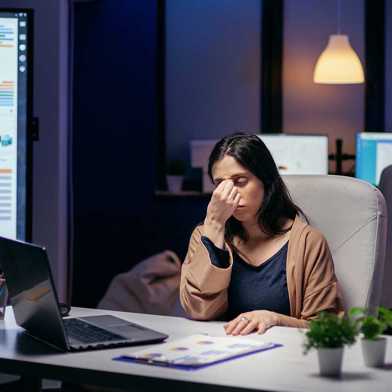 woman sitting at work desk stressed out